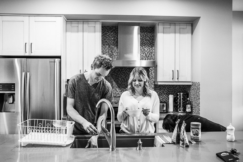 Husband and wife working at the kitchen sink