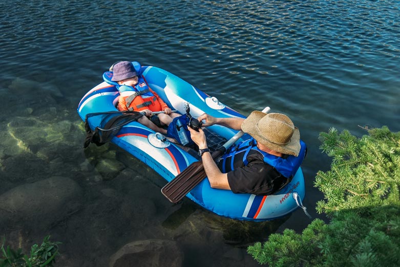 Father and son in inflatable boat
